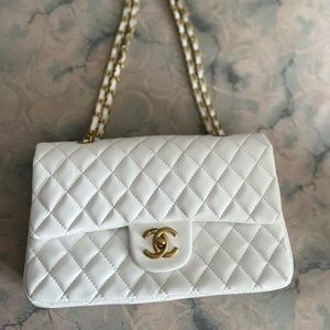 CHANEL. White shoulder/crossbody. I DON’T THINK ITS AUTHENTIC.